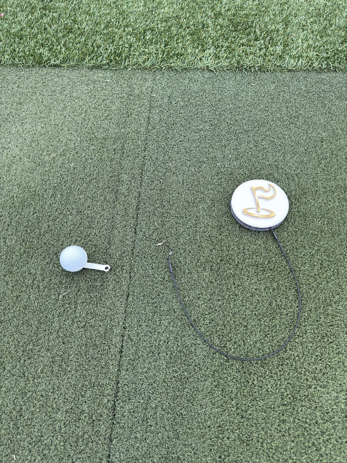 Top-down view of The Perfect Divot set up on a hitting mat